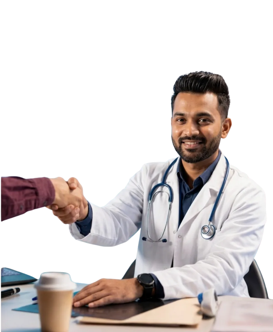 A male doctor smiling while shaking hands with a patient.
