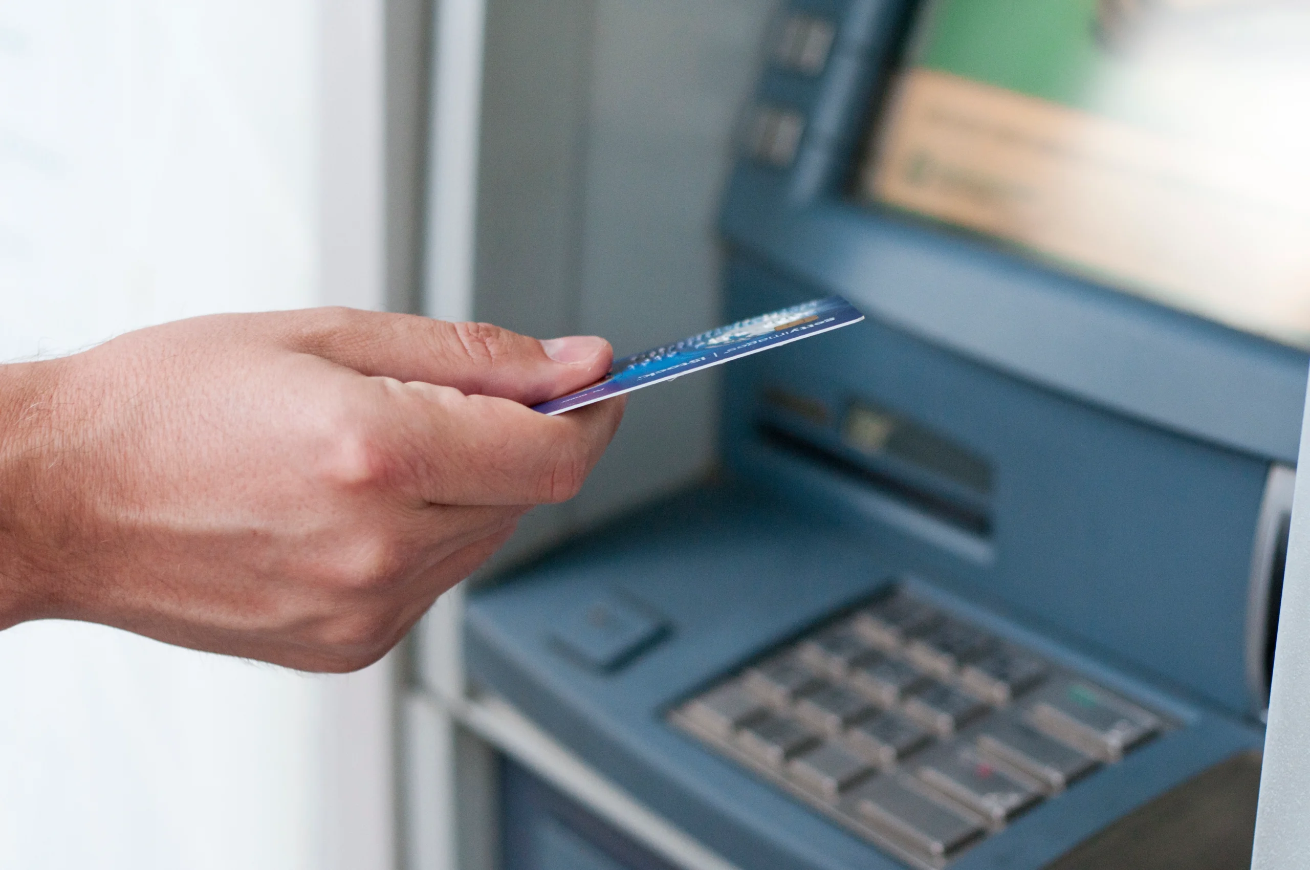 hand-inserting-atm-card-into-bank