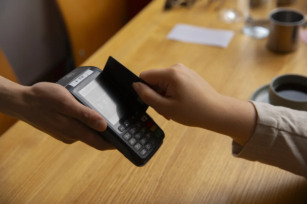 side-view-customer-paying-with-nfc-device